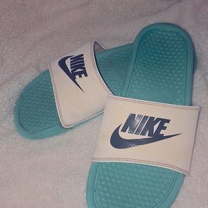 teal and white Nike slides
